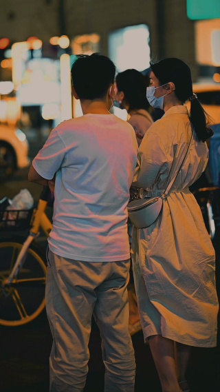 竖屏拍摄年轻男女在商业街散步