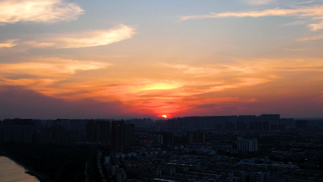 航拍河南洛阳夕阳下的城市建筑