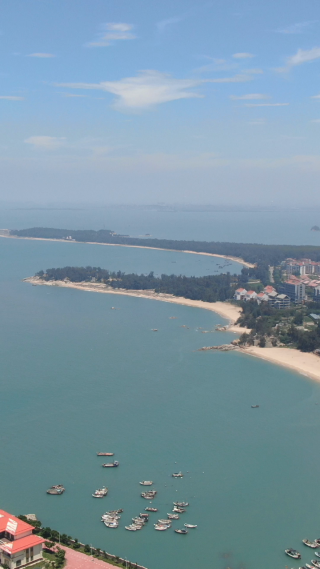 航拍蓝色海边礁石海浪