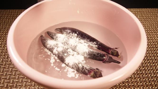 粉色水盆加盐清洗茄子