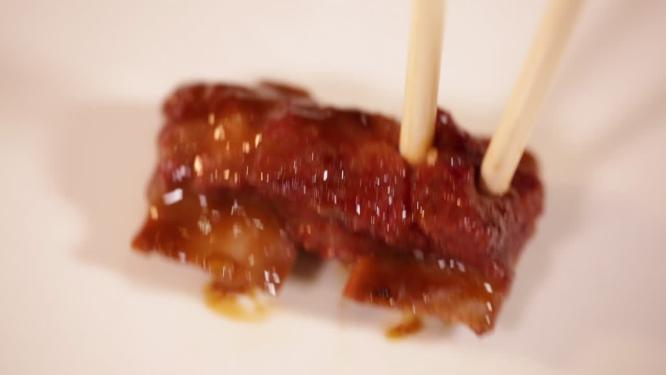 筷子夹起排骨肉
