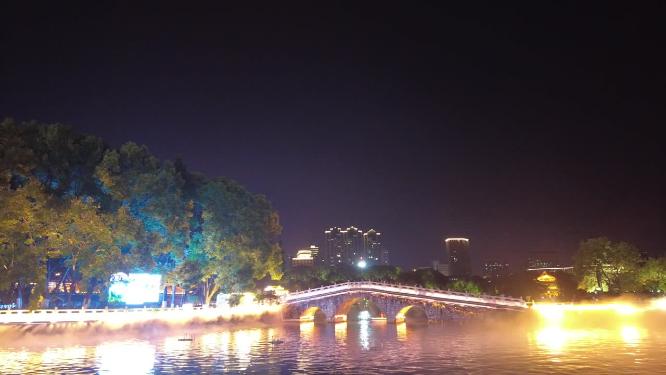 郴州北湖公园灯光秀石拱桥湖面游船城市灯光夜景