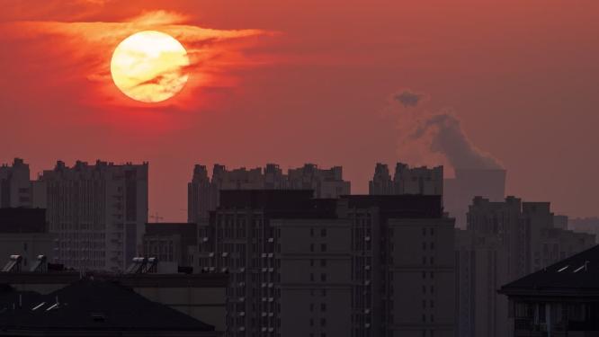 城市日落夕阳太阳发电站化工厂烟囱
