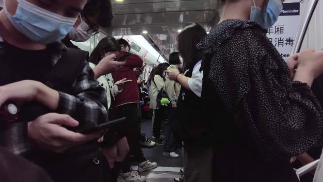 乘坐地铁玩手机的年轻人